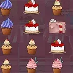 Különféle színes sütemények és muffinok egy rózsaszín háttér előtt