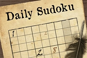 Egy papíron lévő Sudoku feladvány, melyet egy tollal és egy tollpihe díszít