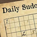 Egy papíron lévő Sudoku feladvány, melyet egy tollal és egy tollpihe díszít