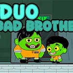 Két zöld színű karakter narancssárga ruhában egy DUO BAD BROTHERS felirat előtt áll