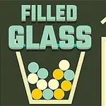 Filled Glass felirat, színes golyókkal teli pohár egy sötét háttér előtt