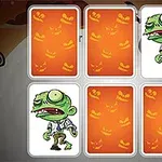 Kártyalapok hátoldalai narancssárga Halloween-mintával, két felfordított lapon zombi rajza látható