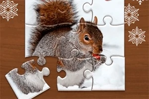 Egy hófehér háttér előtt egy mókust ábrázoló puzzle, amelyből néhány darab hiányzik