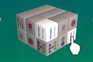 Egy zöld háttér előtt fehér és mintás kockákból álló 3x3x3-as puzzle-kocka, amelyre egy rajzolt kézmutató ujj mutat