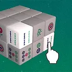 Egy zöld háttér előtt fehér és mintás kockákból álló 3x3x3-as puzzle-kocka, amelyre egy rajzolt kézmutató ujj mutat