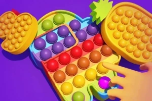 Színes pop it játék sárga, piros, zöld és kék buborékokkal, amelyekből egy kéz egyet benyom
