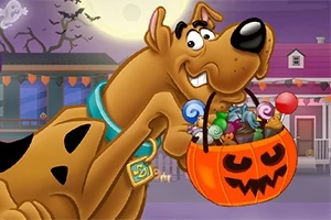Rajzfilmfigura egy töklámpás formájú vödörben édességekkel, háttérben halloween díszlet látható