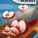 Egy kés szeletel fel egy piros almát, háttérben egy csillaggyümölccsel és más színes gyümölcsökkel