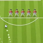 Zöld futballpálya középvonalán öt játékos sorakozik egy egyenes vonalban, a labda pedig ívelt útvonalon közelít feléjük