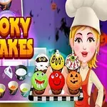 Rajzfilmfigura séf halloween témájú muffinokat tart, háttérben konyhai eszközök és színes edények
