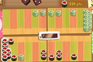 Színes sushi darabok vannak elrendezve egy mintás felületen, középen egy fehér tányéralátét társaságában