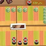 Színes sushi darabok vannak elrendezve egy mintás felületen, középen egy fehér tányéralátét társaságában