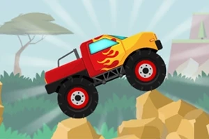 Piros és sárga színű monster truck lángmintával, sziklákon hajt keresztül egy természetes környezetben