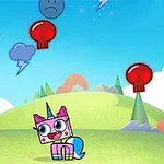 Egy színes, rajzfilmszerű táj közepén egy kocka alakú egyszarvú karakter áll, körülötte piros koponyás és kék szomorú arcú ballonok lebegnek